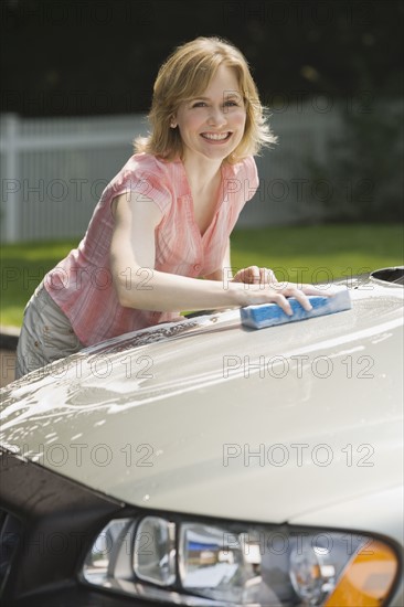 Woman washing car.