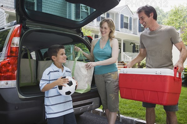 Family loading car for picnic.