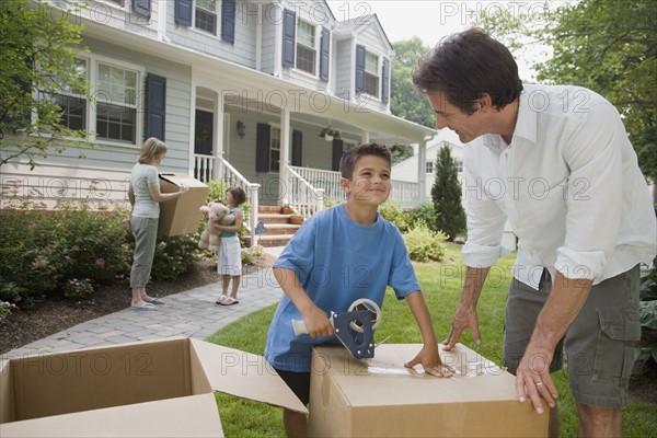 Family packing moving boxes.