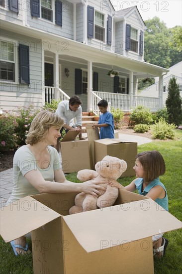 Family unpacking moving boxes.