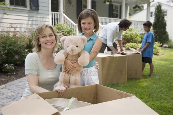 Family unpacking moving boxes.