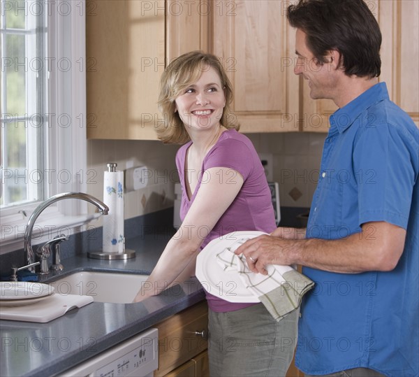 Couple washing dishes.