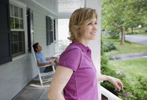 Couple relaxing on porch.