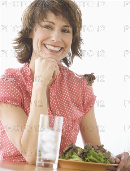 Woman eating salad.