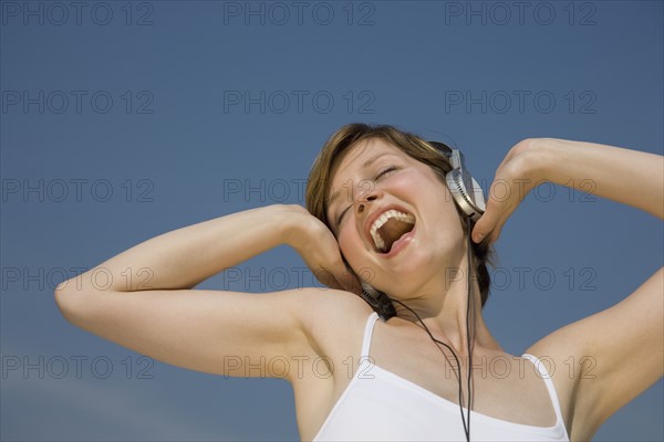 Woman listening to headphones.