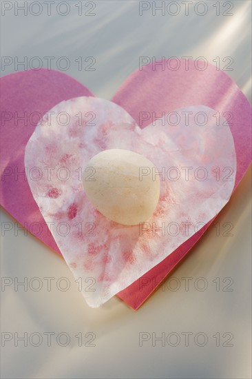 Candy on heart-shaped paper.