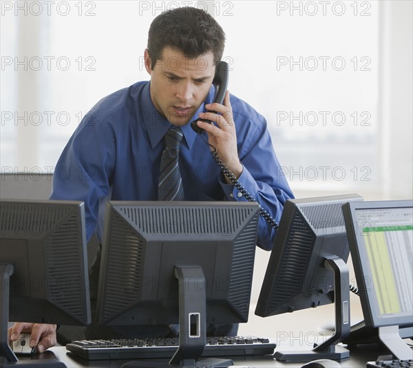 Businessman talking on telephone.