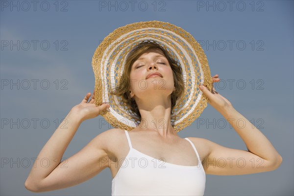 Woman wearing sunhat.