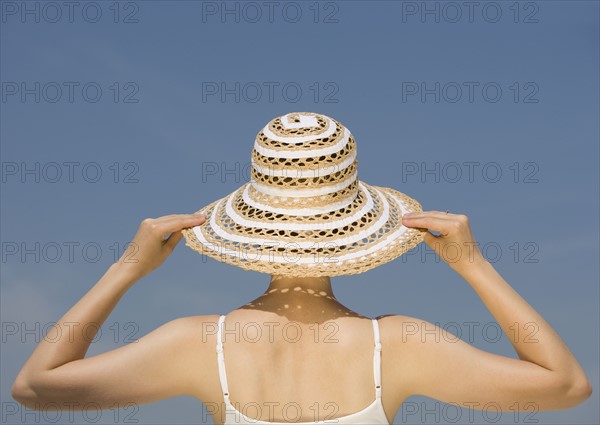 Woman wearing sunhat.