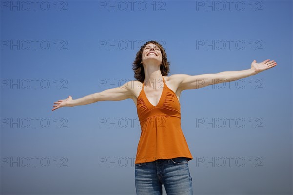 Woman with arms outstretched.