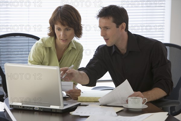 Couple paying bills online.