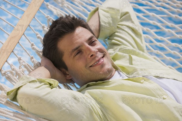 Man laying in hammock.