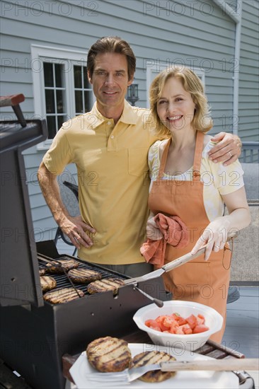 Family barbequing on deck.