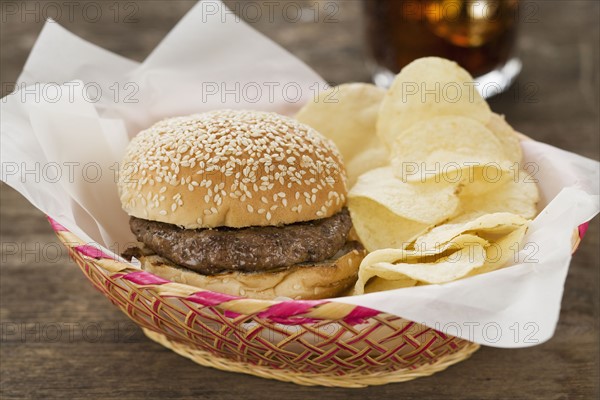 Hamburger and chips in basket.