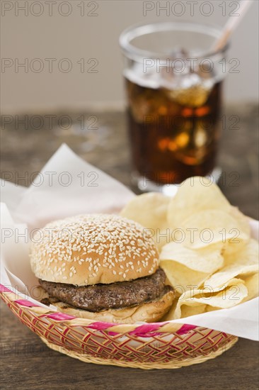 Hamburger and chips in basket.