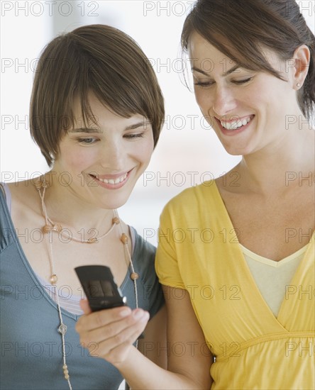 Two women looking at cell phone.