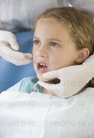 Girl being examined by dentist.