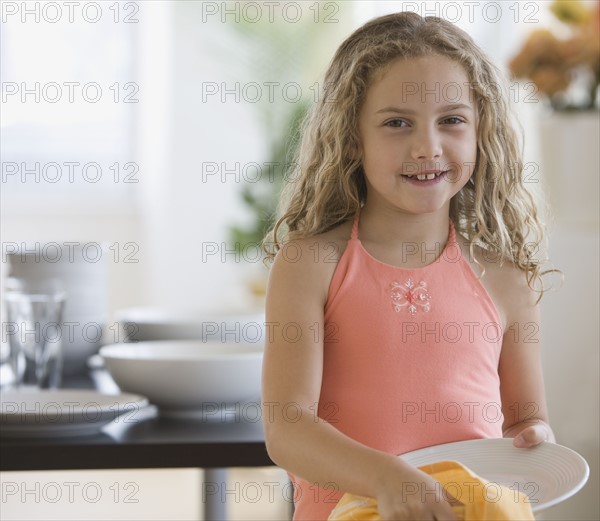 Girl drying off dish.