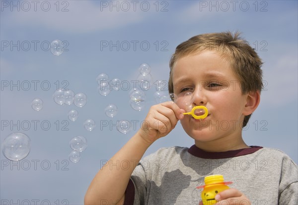 Boy blowing bubbles.