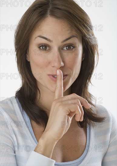 Close up of woman shushing.