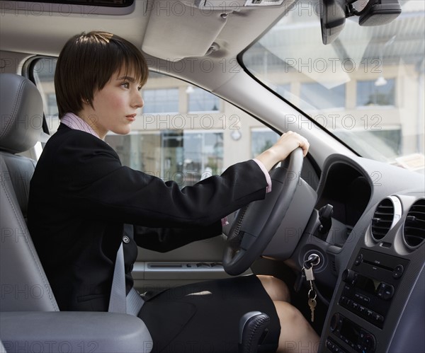 Businesswoman driving car.