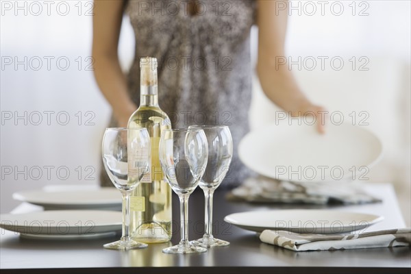 Woman setting table.