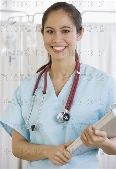 Female doctor holding chart.