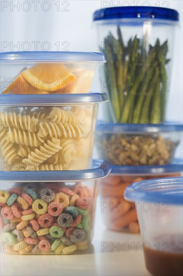 Stacked plastic containers of food.