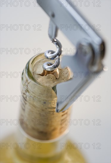 Close up of corkscrew in wine bottle.