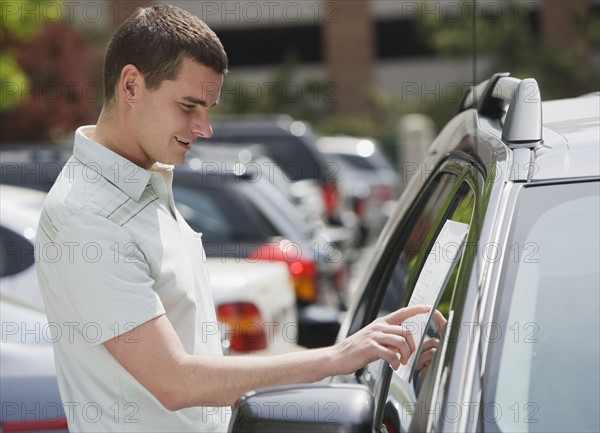 Man looking at new car.