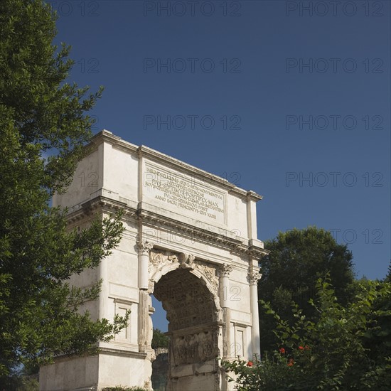 The Arch of Titus under blue sky, Roman Forum, Italy.