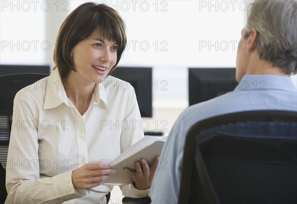 Businesswoman talking to coworker.