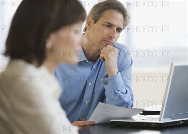 Businessman looking at laptop.