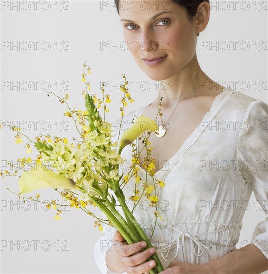 Woman holding bouquet of flowers.