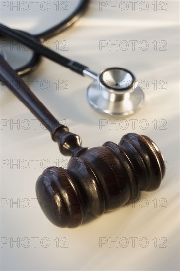 Judge’s gavel next to stethoscope.