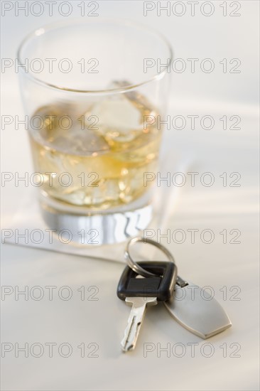 Car keys next to cocktail.