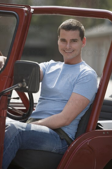 Man sitting in jeep.