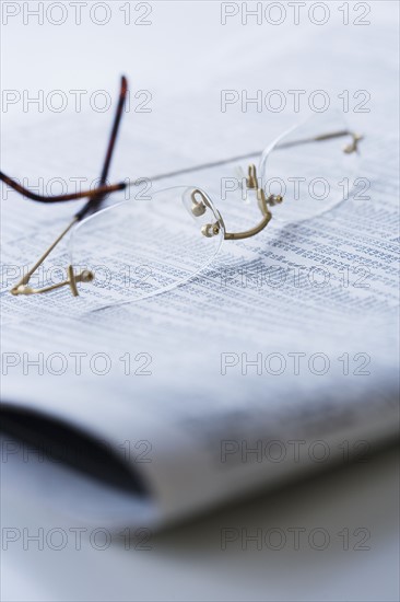 Eyeglasses on newspaper.