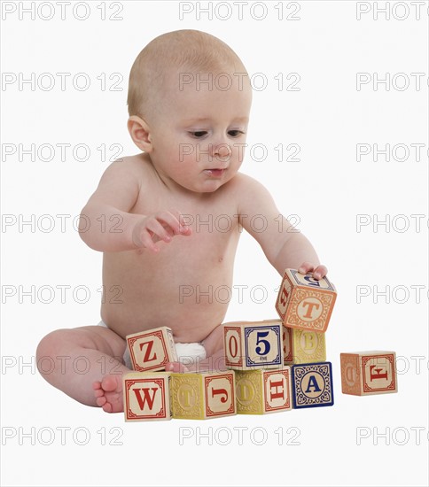 Studio shot of baby playing with blocks.