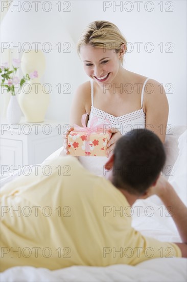 Woman holding gift from husband.