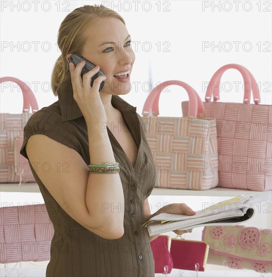 Woman talking on cell phone in boutique.