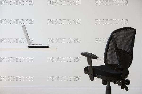 Empty desk with laptop.