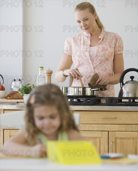 Mother watching daughter color.