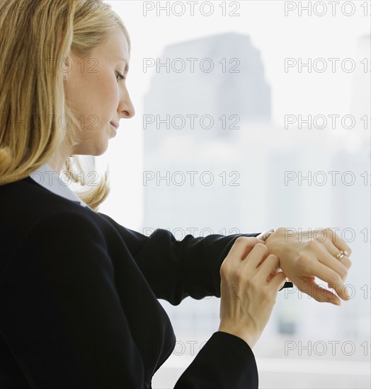 Businesswoman checking watch.