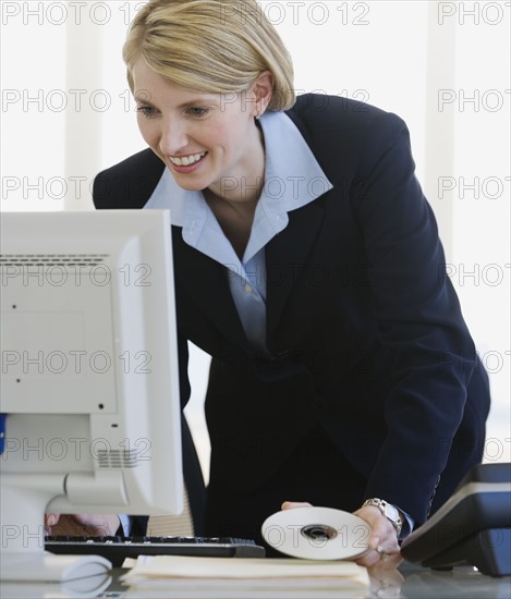 Businesswoman looking at computer.