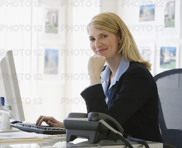 Businesswoman sitting at desk.