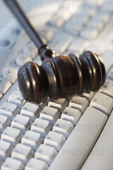 Judge’s gavel on computer keyboard.