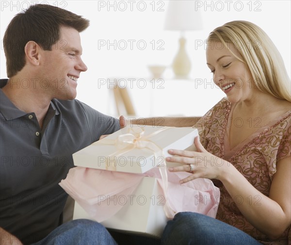 Woman opening gift from husband.