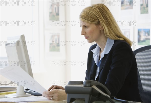 Businesswoman looking at paperwork.