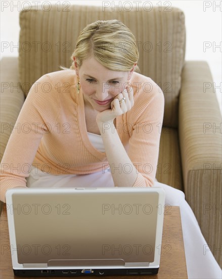 Woman looking at laptop.